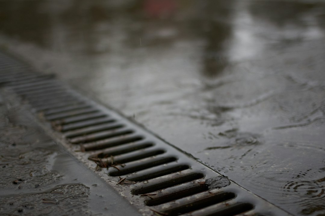 Metal floor drain grate on a wet surface